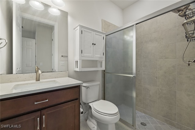 bathroom featuring vanity, toilet, and an enclosed shower