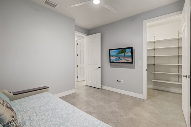 bedroom featuring ceiling fan, a spacious closet, and a closet