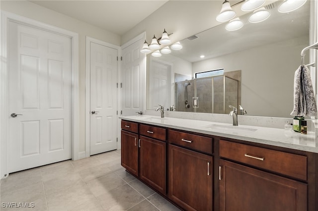 bathroom with vanity, an enclosed shower, and tile patterned flooring