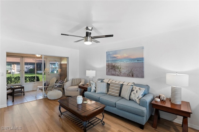 living room featuring light wood-type flooring and ceiling fan