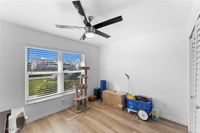 misc room with light hardwood / wood-style flooring and ceiling fan