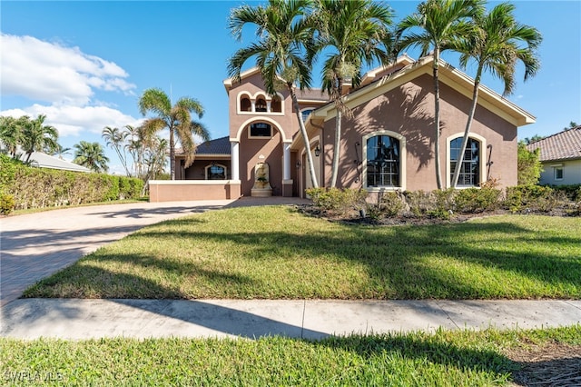 mediterranean / spanish-style home with a front yard