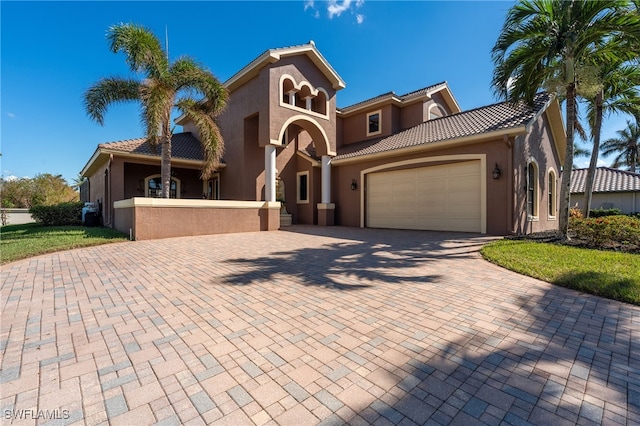 mediterranean / spanish home with a garage