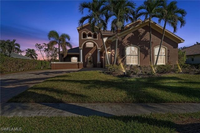 mediterranean / spanish-style house featuring a lawn