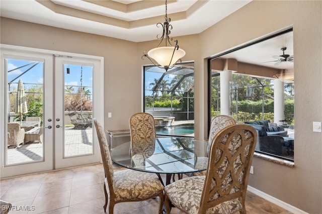 dining space with french doors, plenty of natural light, ceiling fan, and light tile patterned floors