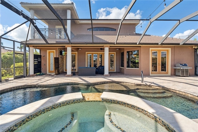 view of swimming pool with french doors, ceiling fan, an in ground hot tub, and a patio area