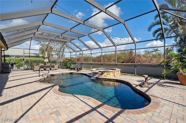 view of swimming pool with a patio, glass enclosure, and an in ground hot tub