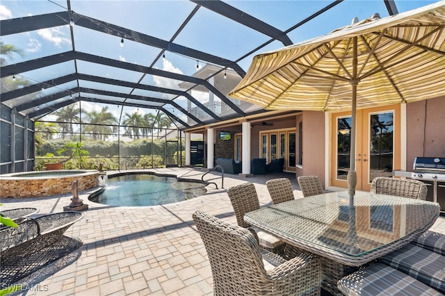 view of pool featuring an in ground hot tub, ceiling fan, a lanai, a patio area, and french doors