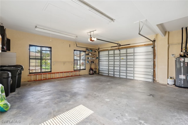 garage featuring electric water heater and a garage door opener