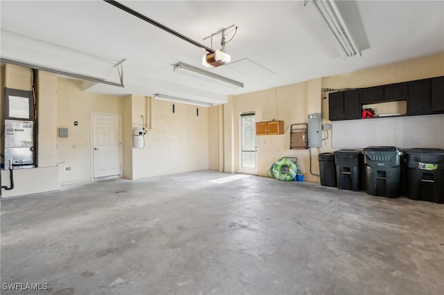 garage featuring electric panel and a garage door opener