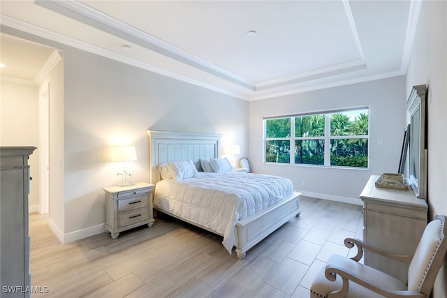 bedroom with a tray ceiling and ornamental molding