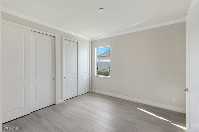 unfurnished bedroom featuring crown molding