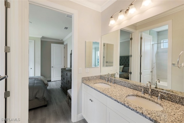 bathroom featuring vanity, hardwood / wood-style floors, and crown molding