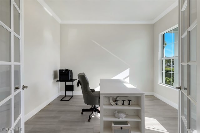 office space with crown molding, light hardwood / wood-style floors, and french doors