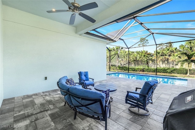 view of patio with ceiling fan and glass enclosure