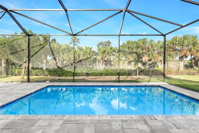 outdoor pool featuring a patio area and glass enclosure