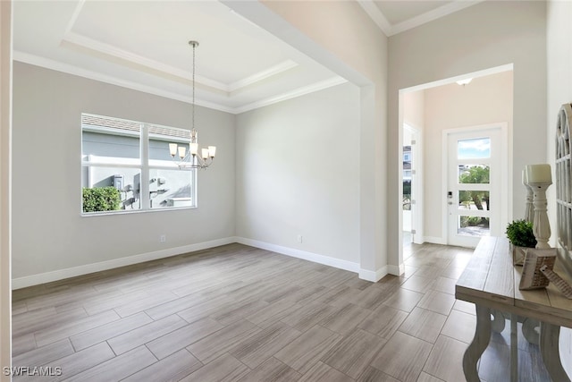 interior space with a chandelier, baseboards, wood tiled floor, a tray ceiling, and crown molding