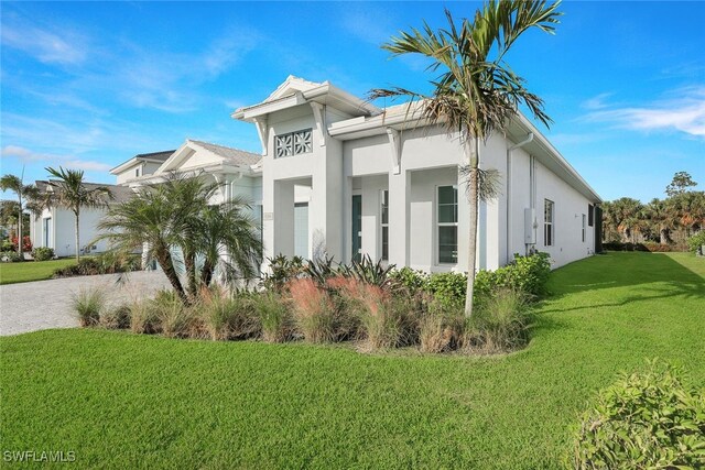 view of front of property with a front lawn and stucco siding