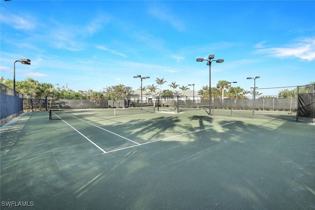 view of tennis court featuring fence