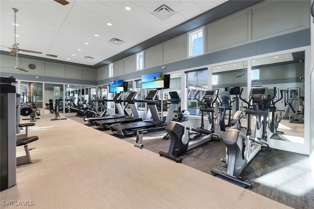 gym with ceiling fan and a towering ceiling