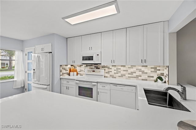 kitchen featuring white cabinets, white appliances, sink, and decorative backsplash