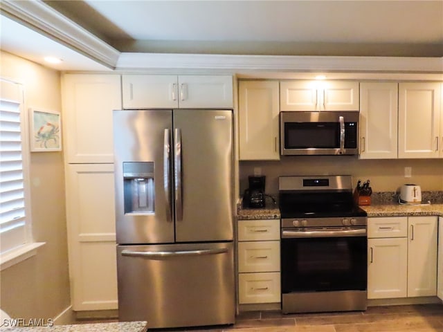 kitchen featuring white cabinets, stainless steel appliances, and stone countertops