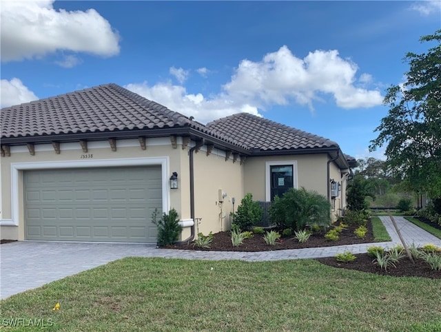 view of front of home with a garage and a front lawn