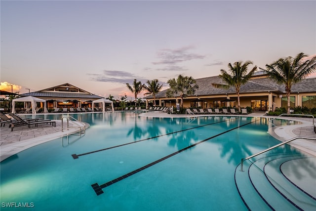 pool at dusk with a patio