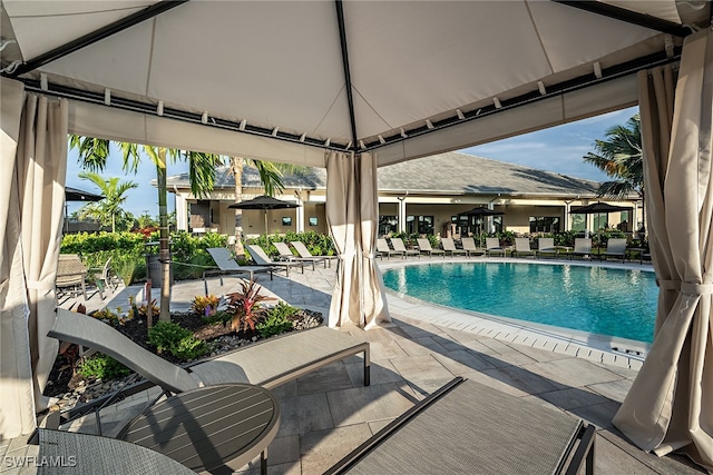 view of swimming pool with a gazebo and a patio area