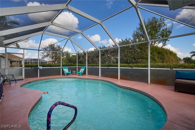 view of swimming pool with a lanai and a patio area