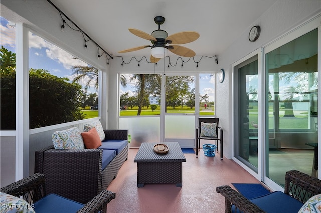 sunroom / solarium featuring ceiling fan