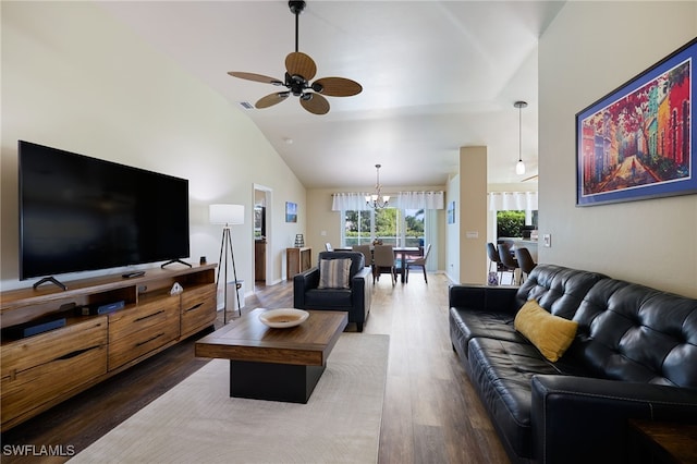 living room with hardwood / wood-style flooring, high vaulted ceiling, and ceiling fan with notable chandelier