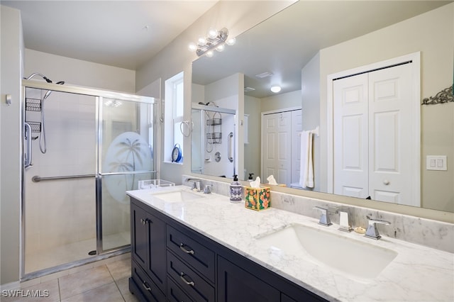 bathroom featuring vanity, tile patterned floors, and a shower with shower door