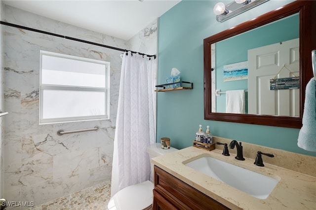 bathroom with walk in shower, vanity, and toilet