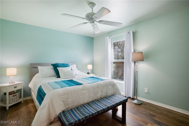 bedroom with dark hardwood / wood-style flooring and ceiling fan