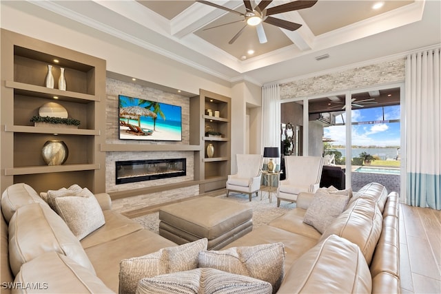 living room featuring beamed ceiling, built in shelves, ceiling fan, and light hardwood / wood-style flooring