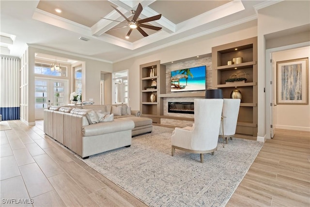 living room with built in features, coffered ceiling, light hardwood / wood-style floors, ornamental molding, and french doors