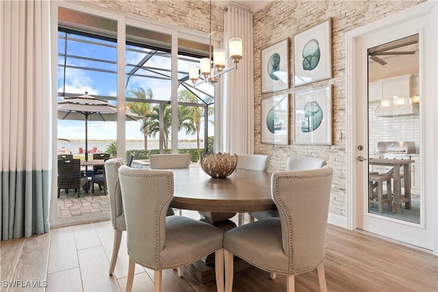 dining area with a chandelier and light hardwood / wood-style flooring