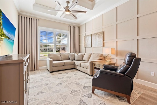 living room with crown molding, light hardwood / wood-style floors, and ceiling fan