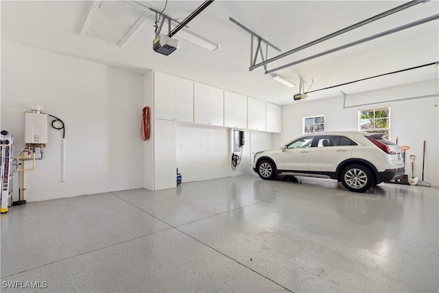 garage with a garage door opener and water heater