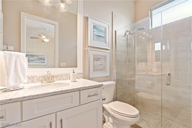 bathroom featuring vanity, an enclosed shower, ceiling fan, and toilet