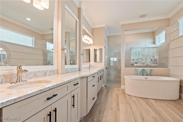 bathroom featuring hardwood / wood-style flooring, vanity, crown molding, and separate shower and tub