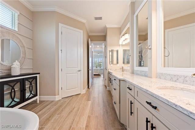 bathroom with vanity, hardwood / wood-style flooring, and ornamental molding