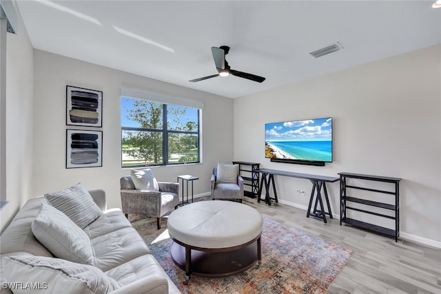 living room with ceiling fan and light hardwood / wood-style flooring