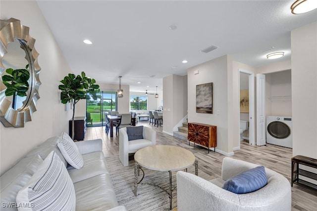 living room featuring light hardwood / wood-style floors and washer / dryer