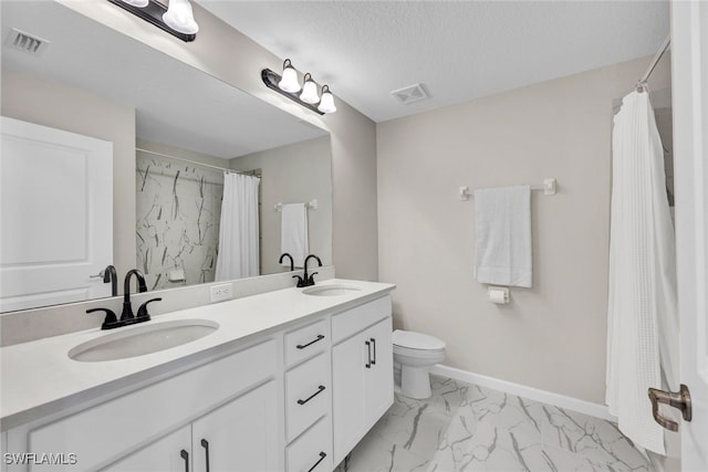 bathroom with a shower with curtain, vanity, a textured ceiling, and toilet