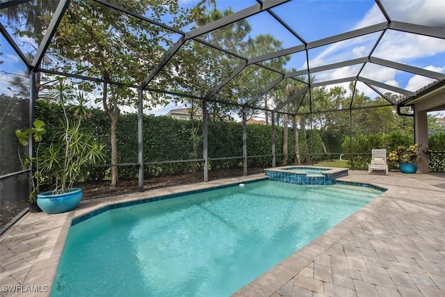 view of swimming pool featuring glass enclosure, an in ground hot tub, and a patio