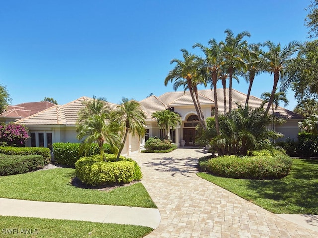 view of front of house with a front yard and a garage