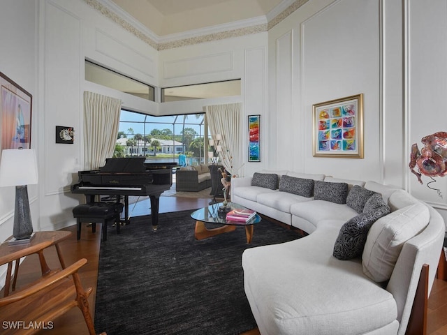 living room featuring hardwood / wood-style flooring and crown molding