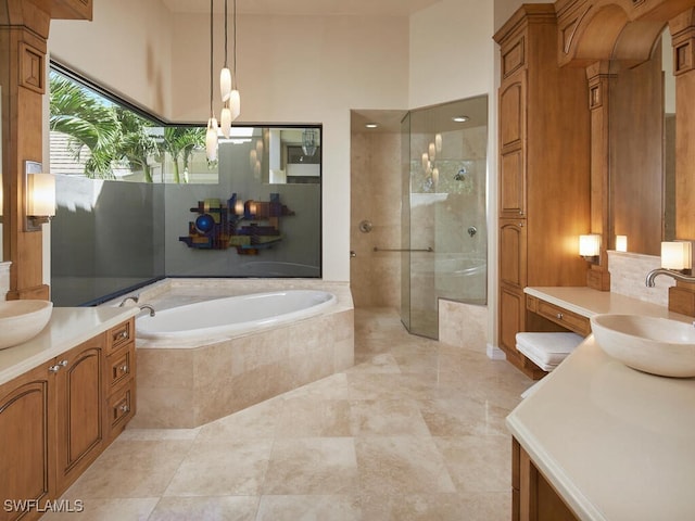 bathroom featuring vanity and shower with separate bathtub